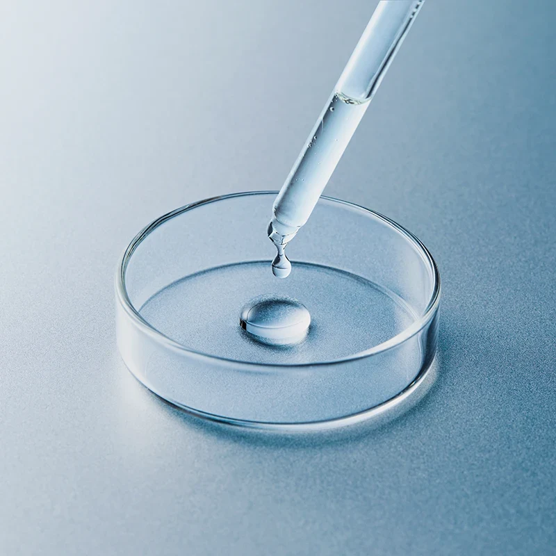 Pipette placing a liquid sample into a petri dish for analytical laboratory testing.