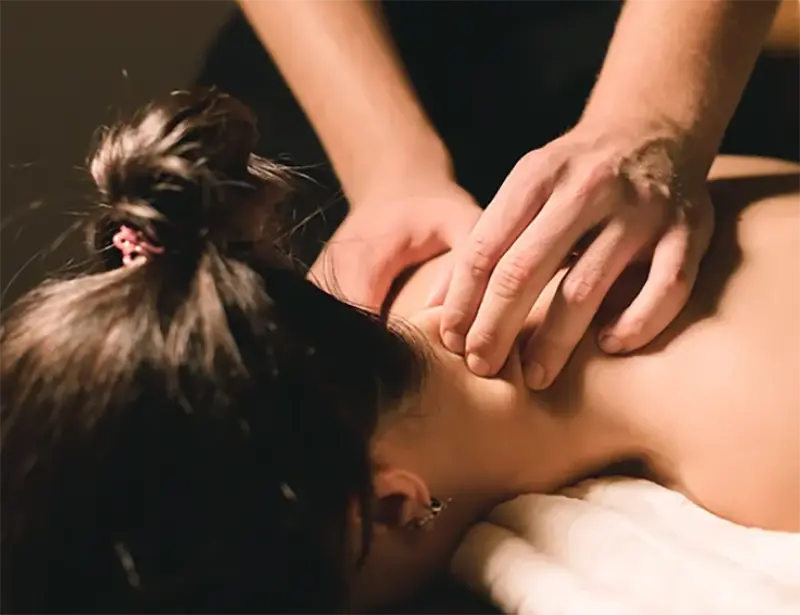 Chiropractic massage therapy session focusing on neck and upper back tension relief.