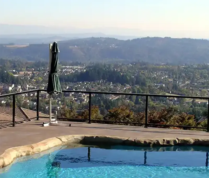 Backyard pool with a hilltop view overlooking the surrounding valley and neighborhoods.