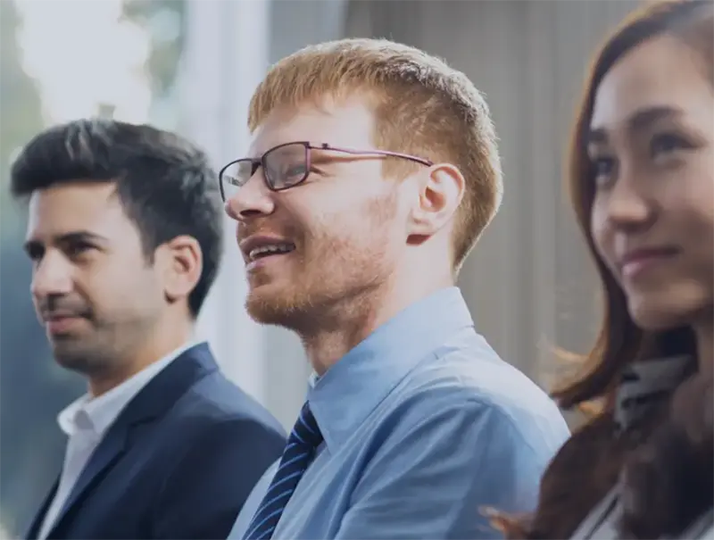 Business professionals sitting together during a meeting or presentation.